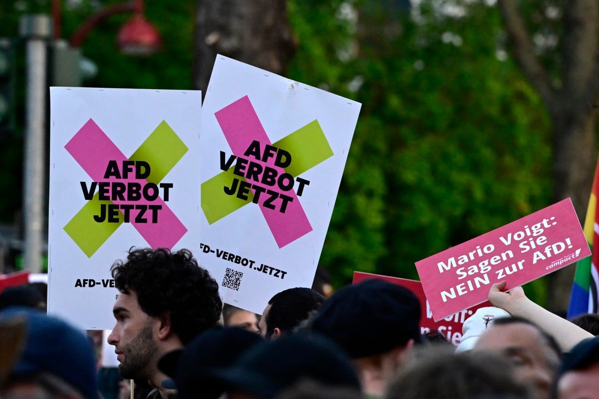 Demonstrators display a banner reading 'AfD ban now' and 'Mario Voigt says no to AfD' during a demonstration in front of Thuringia's State Parliament in Erfurt, eastern Germany, on September 1, 2024, during the Thuringia's regional elections day.