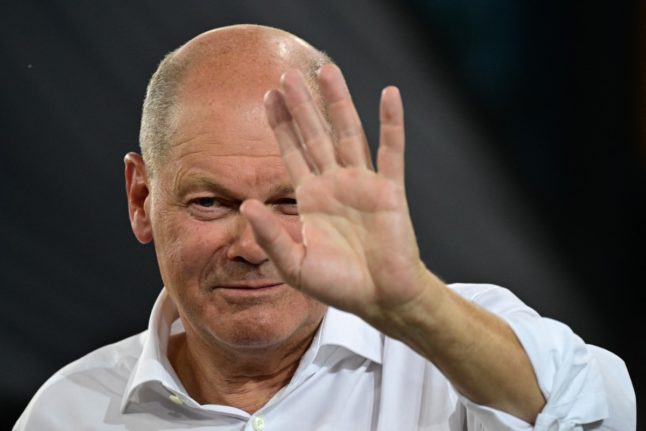 German Chancellor Olaf Scholz speaks and gestures during a 'Chancellor-talk' meeting with citizens in Berlin on September 4, 2024.