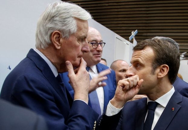 This file photo shows French president Emmanuel Macron (R) with then-Brexit Chief Negotiator Michel Barnier in Paris in 2019.