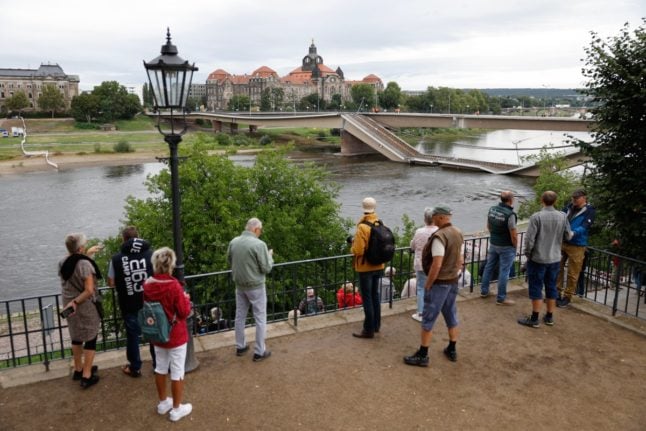 People are seen watching over the partially collapsed Carola Bridge (Carolabruecke) on the Elbe river in the city centre of Dresden, Saxony, eastern Germany, on September 11, 2024.