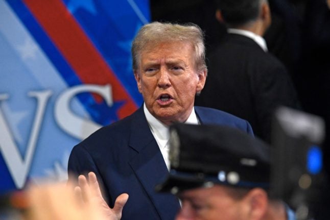 Former US President and Republican presidential candidate Donald Trump speaks to members of the press in the spin room following a presidential debate with US Vice President and Democratic presidential candidate Kamala Harris at the National Constitution Center in Philadelphia, Pennsylvania, on September 10, 2024.