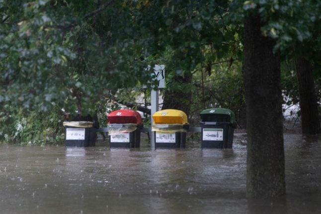 Rubbish bins are seen in the flood waters in the town of Schoenberg am Kamp, about 80 km west of Vienna, Austria o