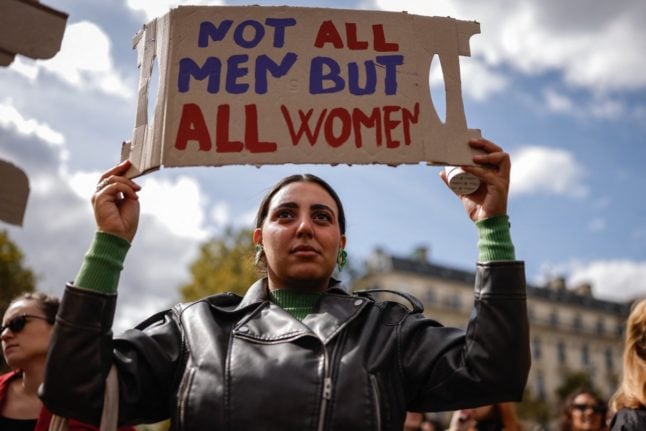 A protester holds a placard as she takes part in a demonstration in support of Gisele Pelicot in Paris