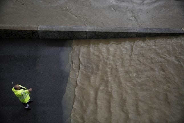 File photo of a member of Italy's Civil Protection department patrolling a flooded street