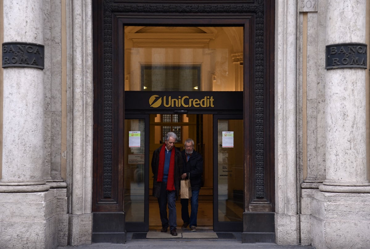 Costumers leave a branch of Italy's Unicredit bank in downtown Rome