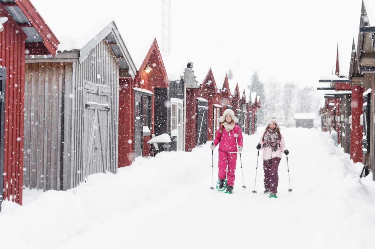 two women walk in the snow in Piteå