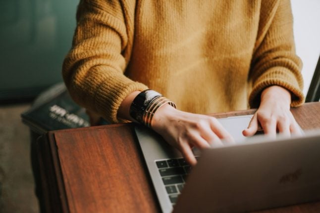 A woman works on her laptop