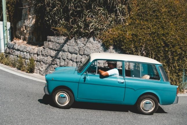 A vintage car pictured on an Italian road