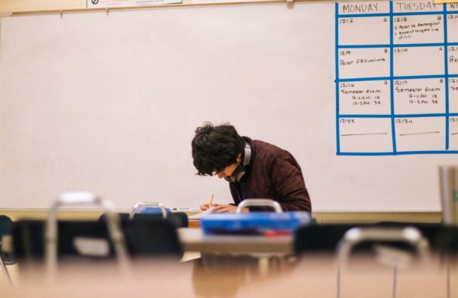 Pictured is a student in a classroom.