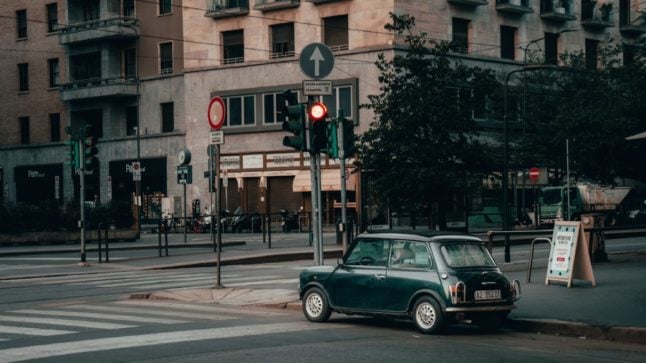 A vintage car pictured at a traffic light in Milan, northern Italy