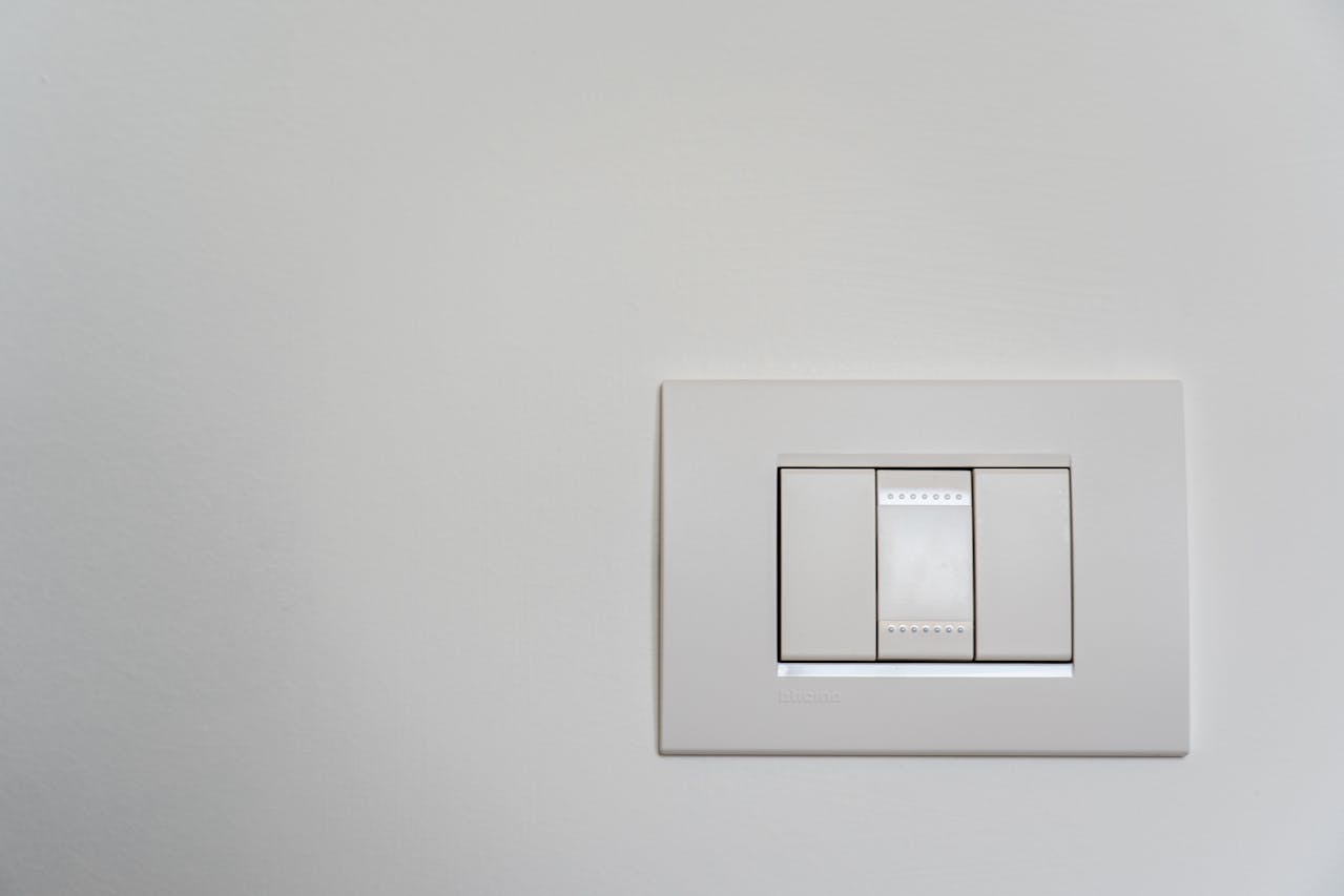 Why do many bathrooms in Spain have the light switch outside?