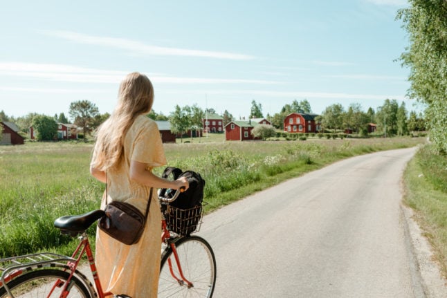 a woman on a bicycle in the countryside outside Umeå