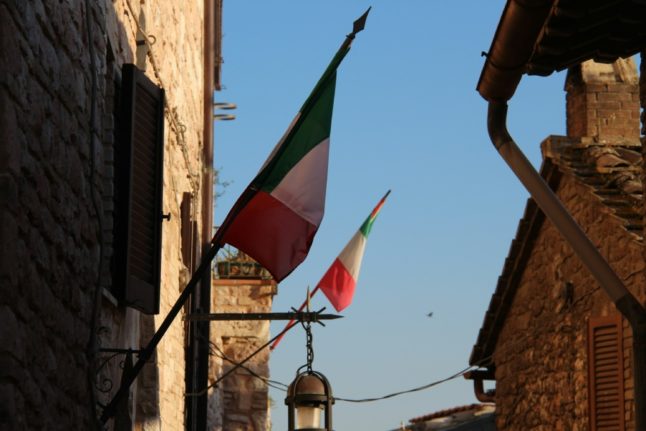 Italian flags pictured in an alley in Assisi, near Perugia, Umbria.