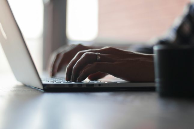 Pictured is a person working on a computer.