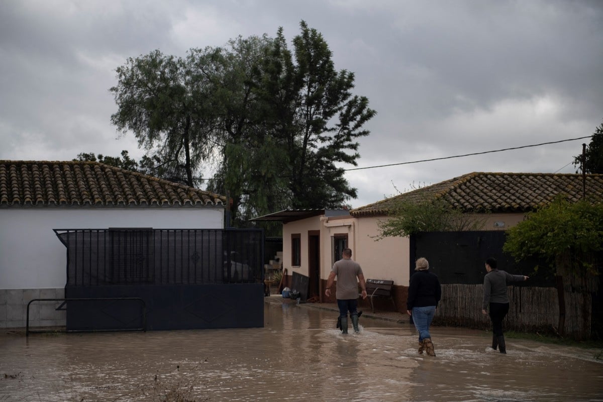 Which parts of Spain are still being affected by storms and floods?