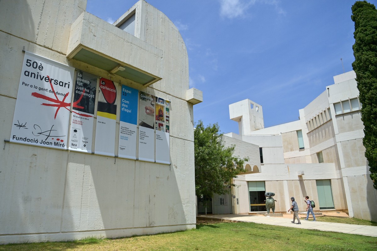 Two people walk past Joan Miro's sculpture titled "Personnage" (1970) as they arrive at the Fundacio Joan Miro art museum in Barcelona