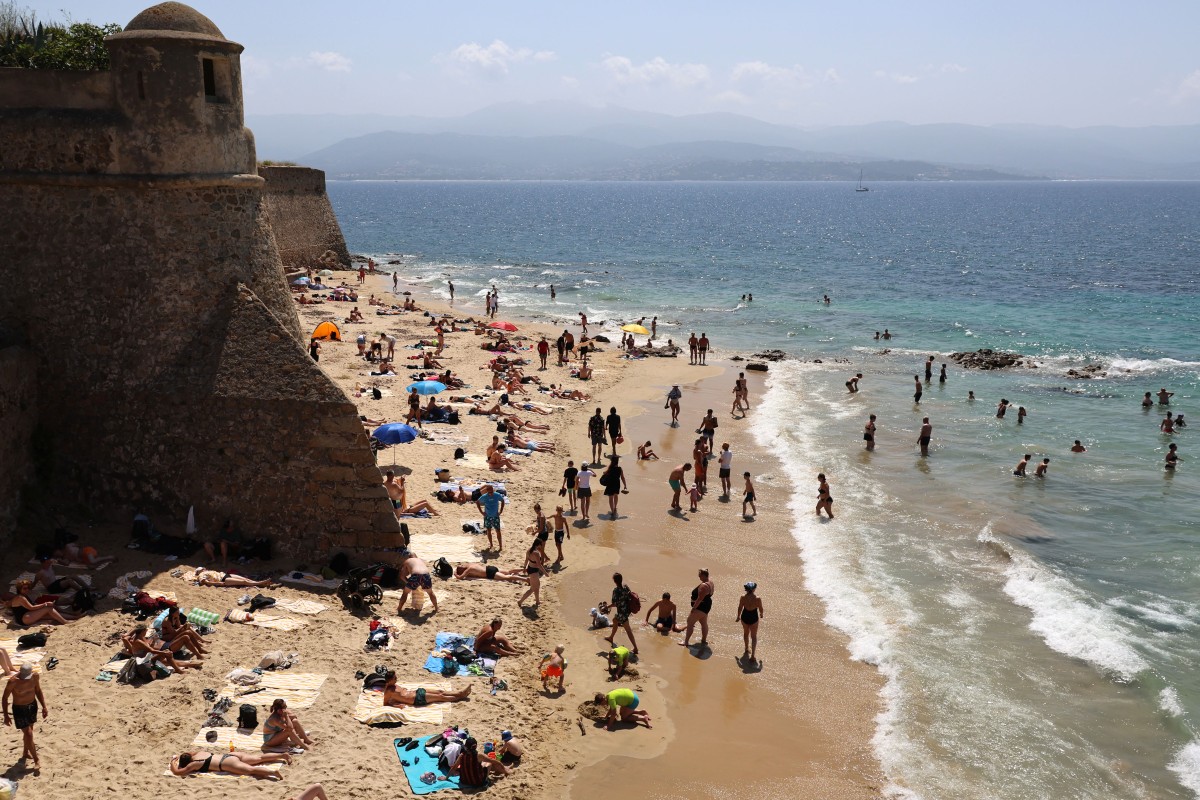 People enjoy Saint François beach in Ajaccio, on the French Mediterranean island of Corsica