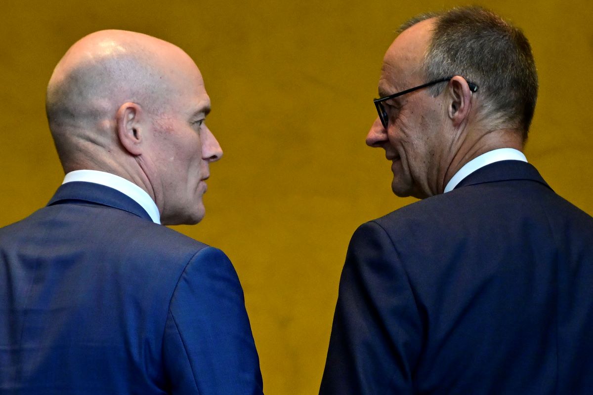 German Chancellor Friedrich Merz (R) chats with Blackrock's Germany manager Dirk Schmitz