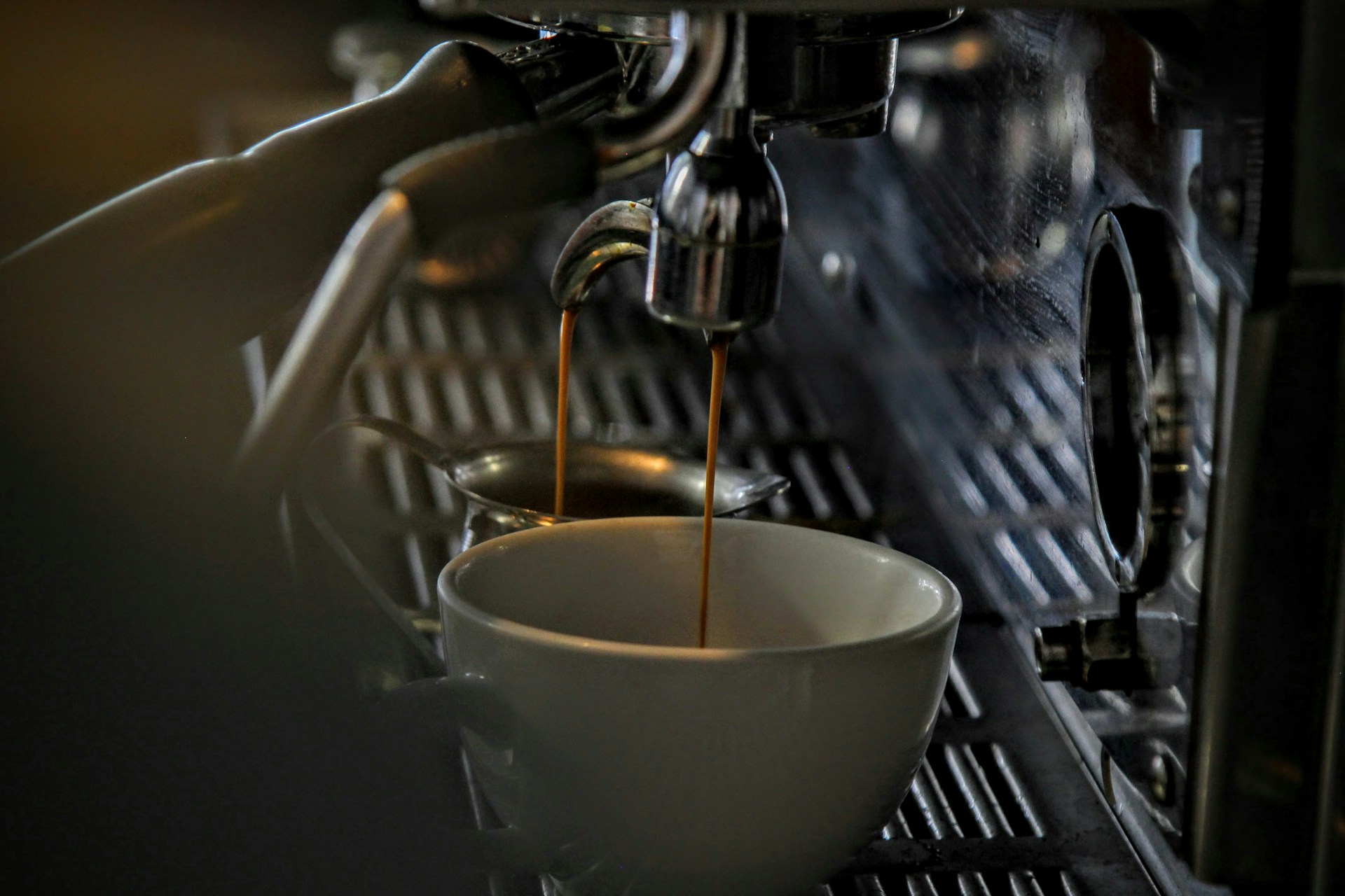 a coffee machine dispensing coffee into a cup