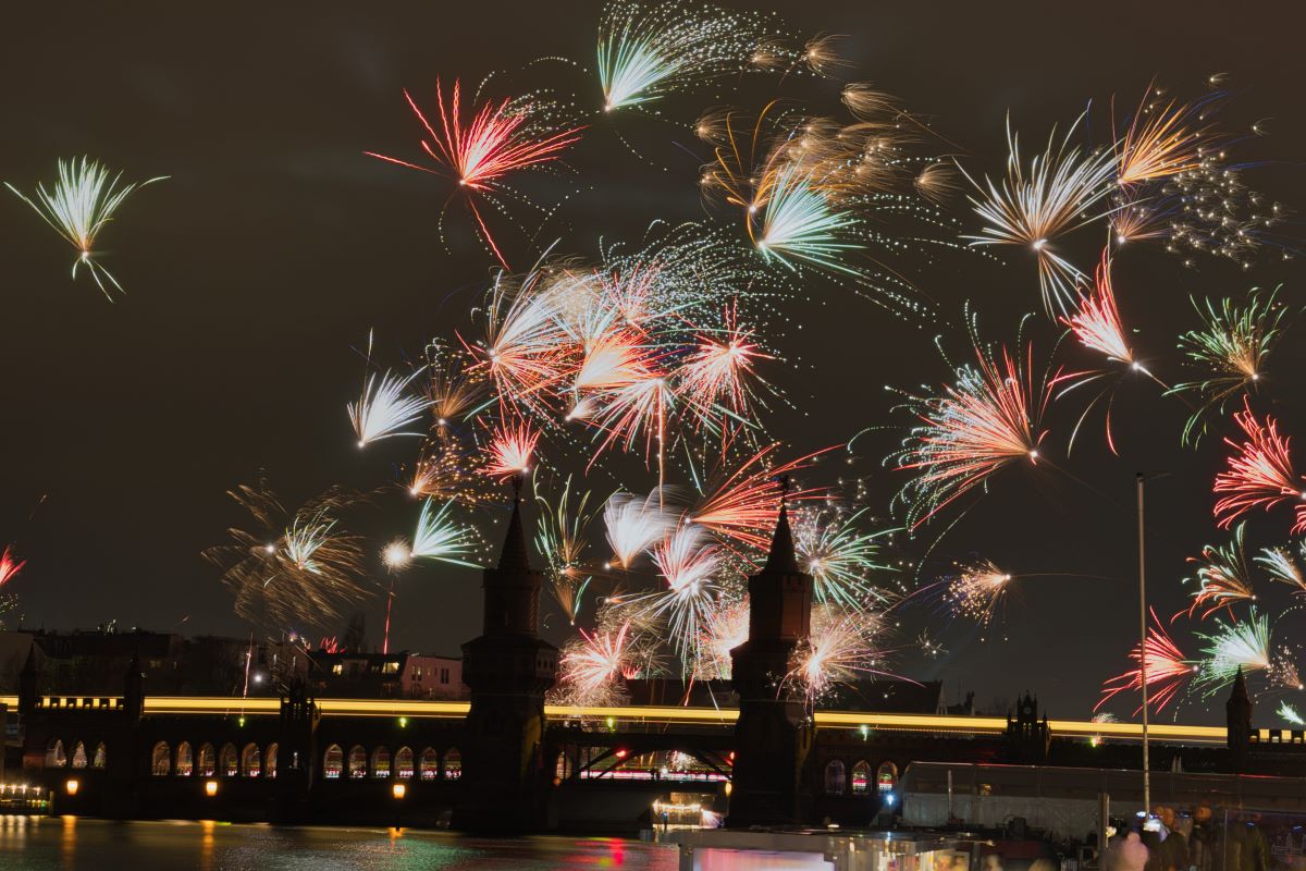 Fireworks go off behind the Oberbaum Bridge