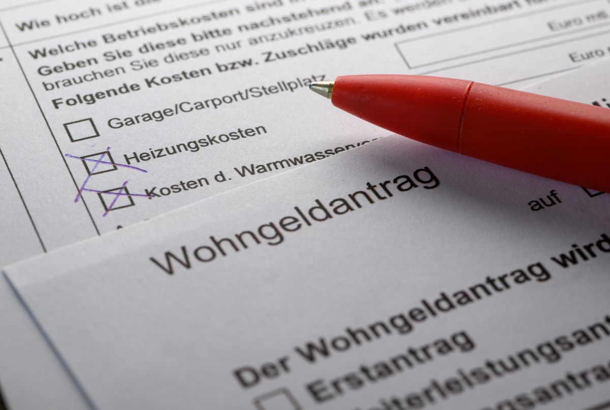 A pen lies on a housing benefit application on a table (staged scene)