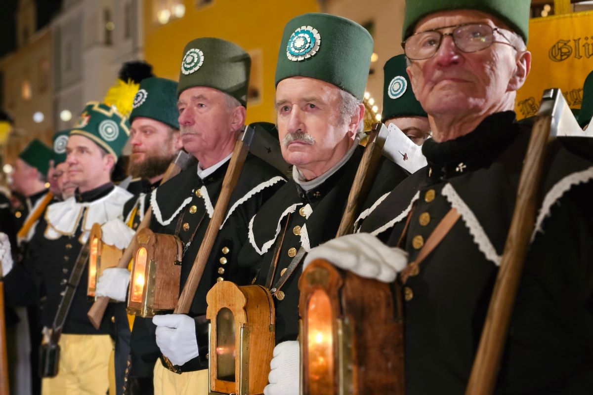 Participants stand with the miners' procession at the traditional mountain parade in Schwarzenberg, Saxony.