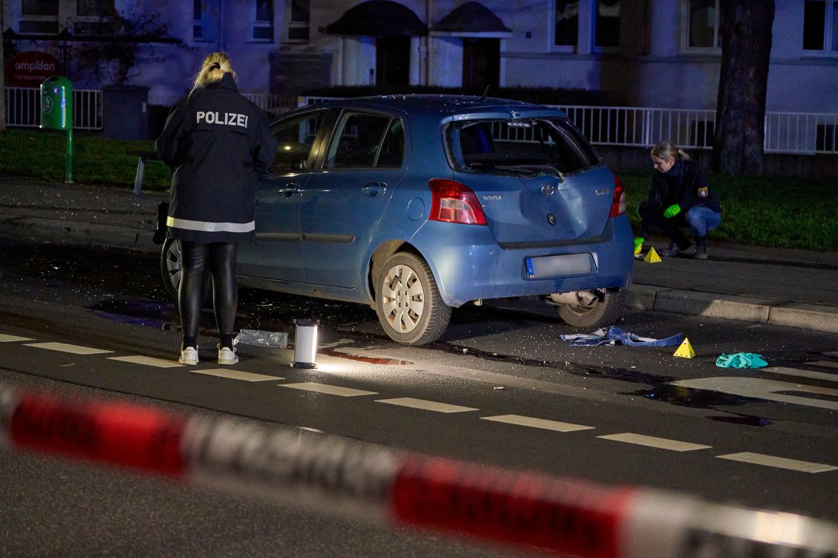 A wrecked car is seen in Giessen while teo police investigate.