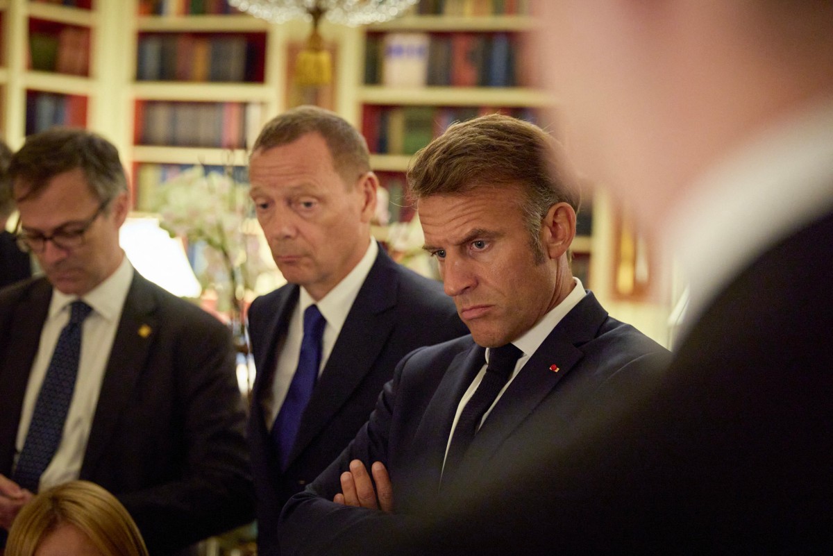 Macron looking stern looks to Zelensky who is off camera at a meeting in Brussles.
