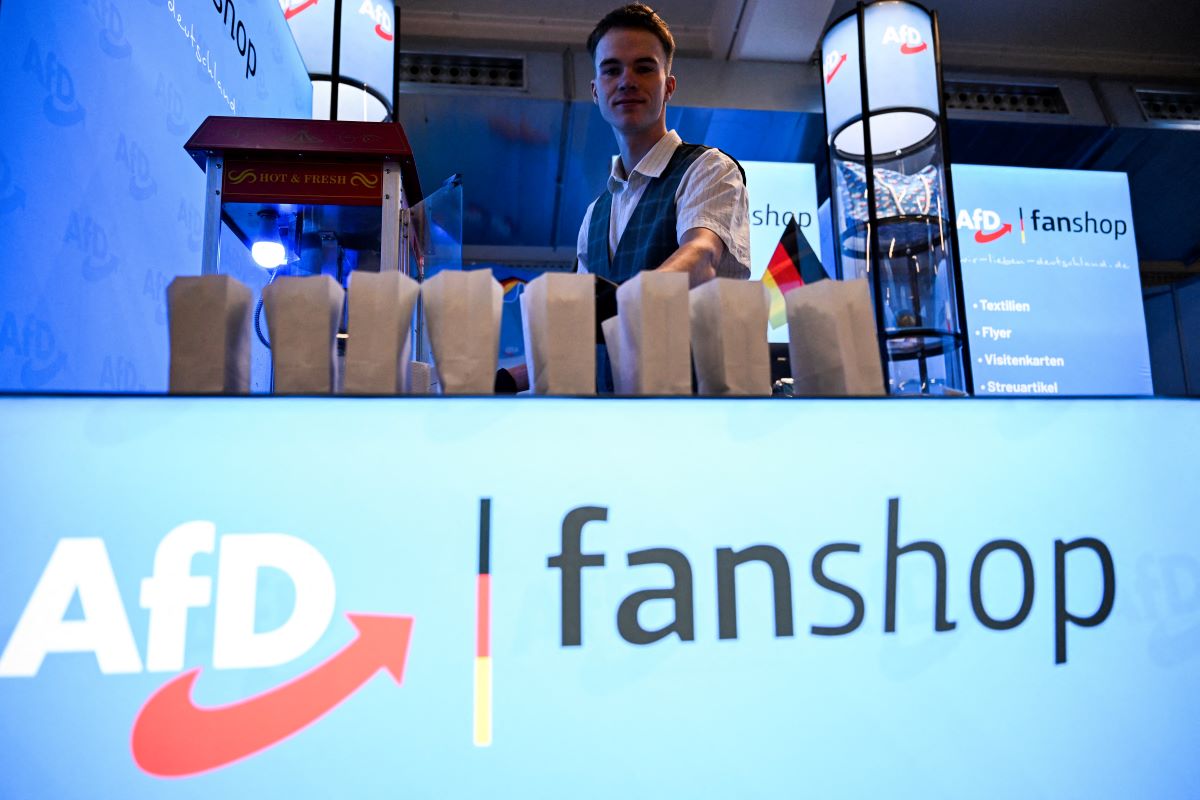 A vendor stands in an "AfD fanshop" 