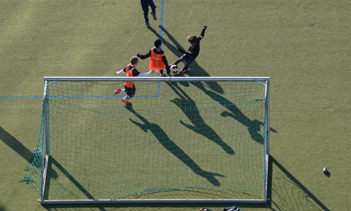 Children play football on an artificial pitch in Germany