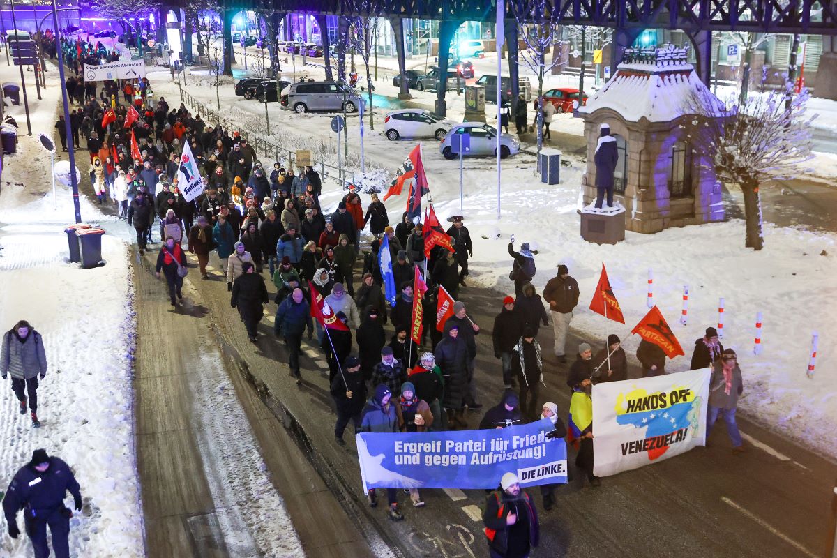 Participants demonstrate after the US attacks on Venezuela and march along the harbour in Hamburg.