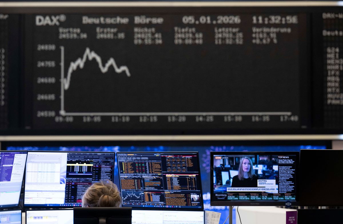 Stock traders monitor price movements on their screens at the Frankfurt Stock Exchange. 