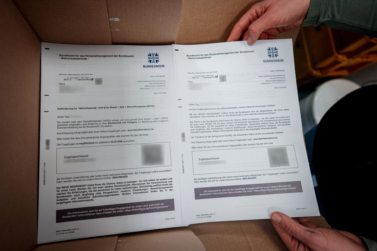 German military service questionnaires stacked in a box