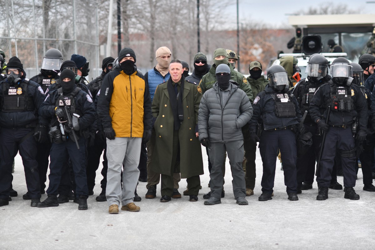 US Customs and Border Protection Commander Gregory Bovino (C) stands flanked by fellow federal agents. 