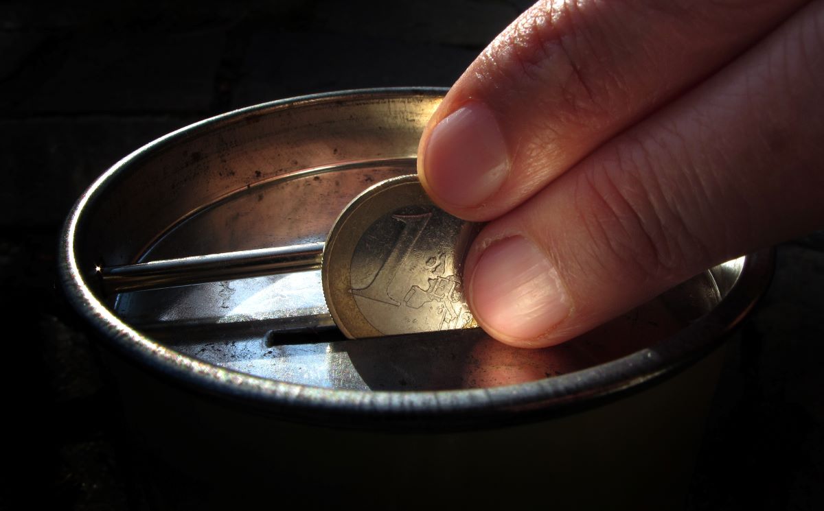 On November 18, 2011, in Kaufbeuren (Swabia), a hand puts a one-euro coin into a collection box. 