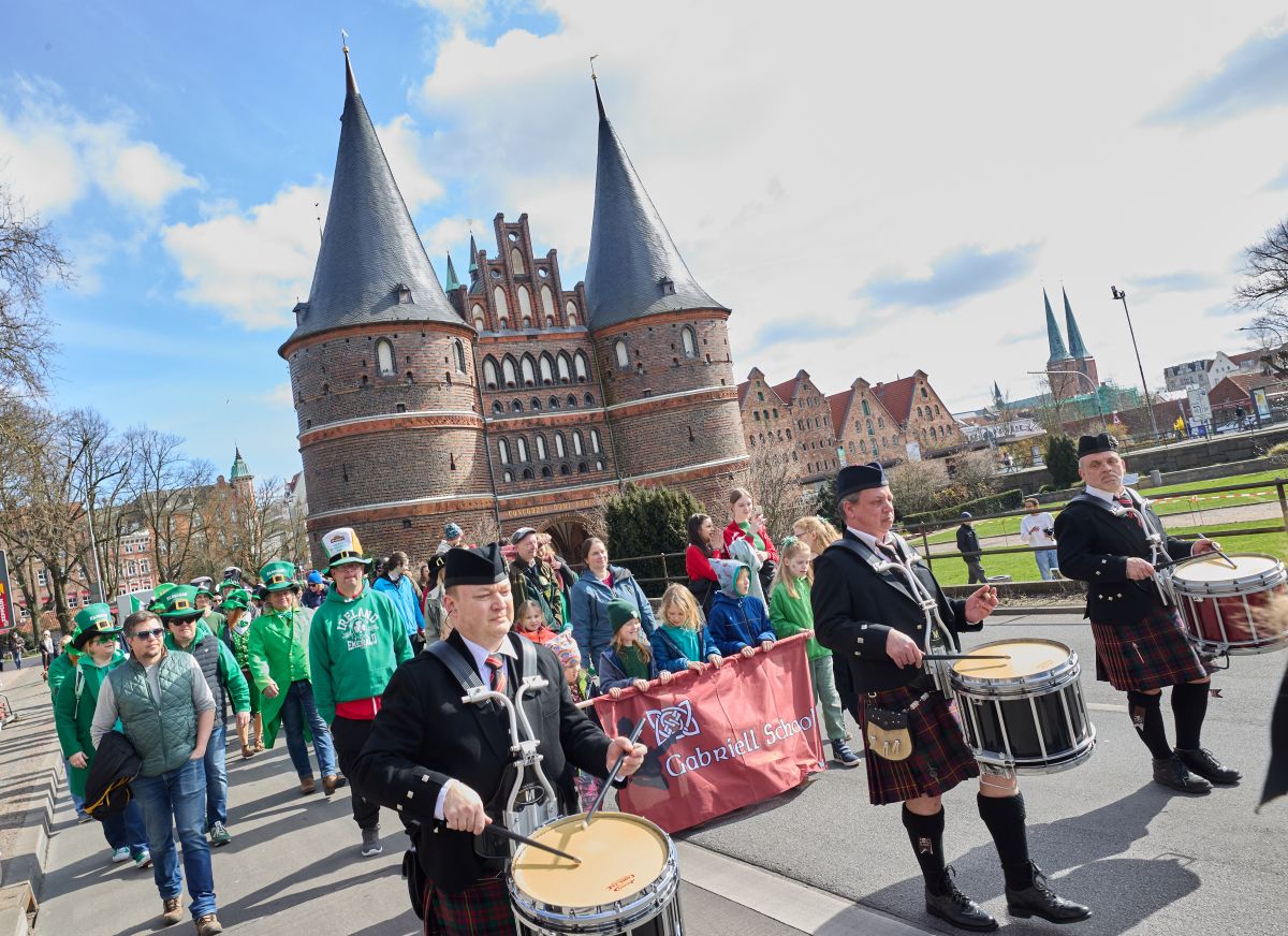 People walk in a st patricks day parade in the city of Lubeck.