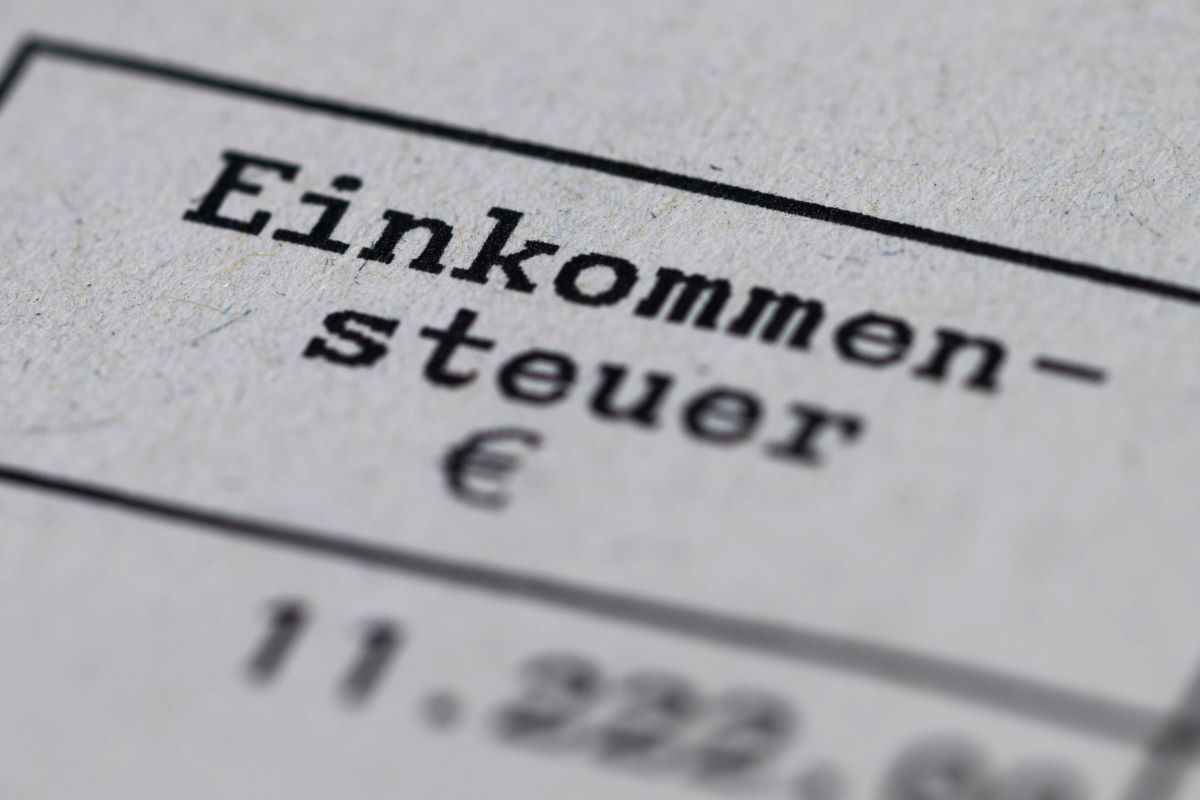 A tax assessment notice marked “income tax” lies on a table.