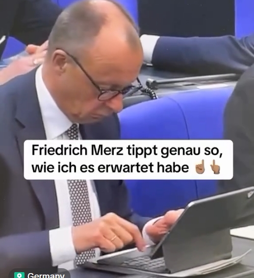 Screenshot shows Merz typing with his pointer fingers.