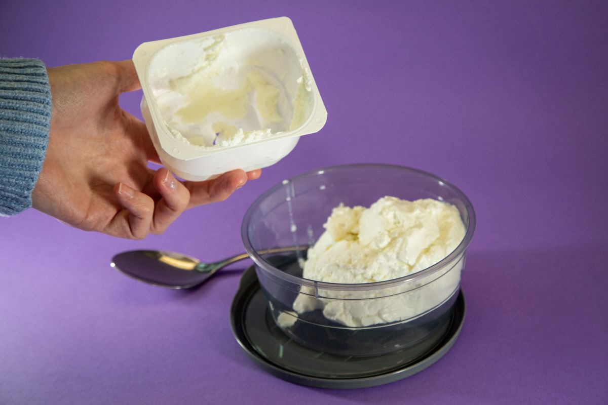 A man empties quark from one container into another