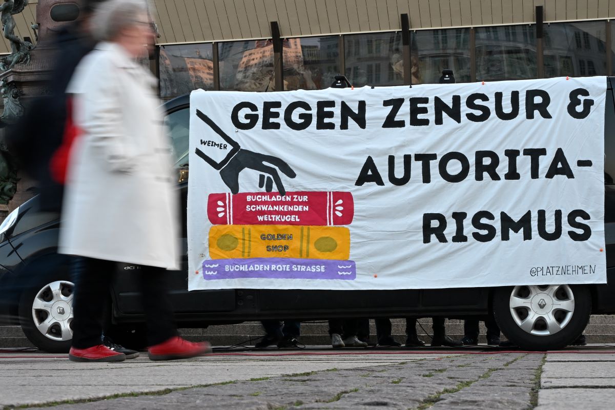 A poster bearing the slogan “Against Censorship & Authoritarianism” hangs in front of the Gewandhaus in Leipzig before the start of the opening ceremony for the Leipzig Book Fair.