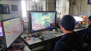 This photo taken on March 16, 2026 in Germany's Kiel bay shows scientists looking at footage of munition on the seabed, aboard the scientific research vessel Alkor, belonging to the Kiel-based GEOMAR oceanographic research centre. 