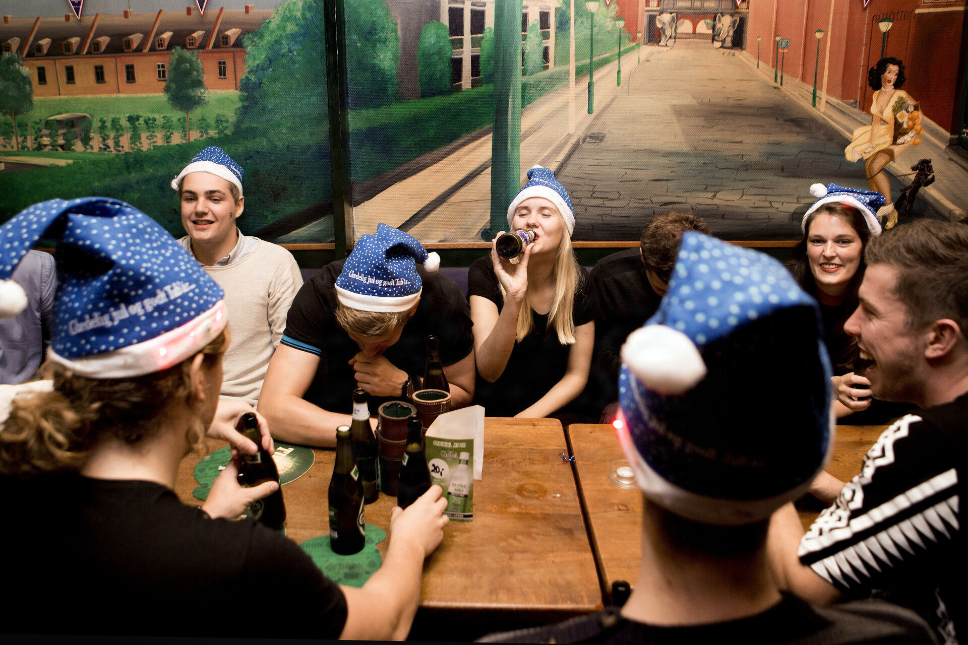 people in bar drinking beer.