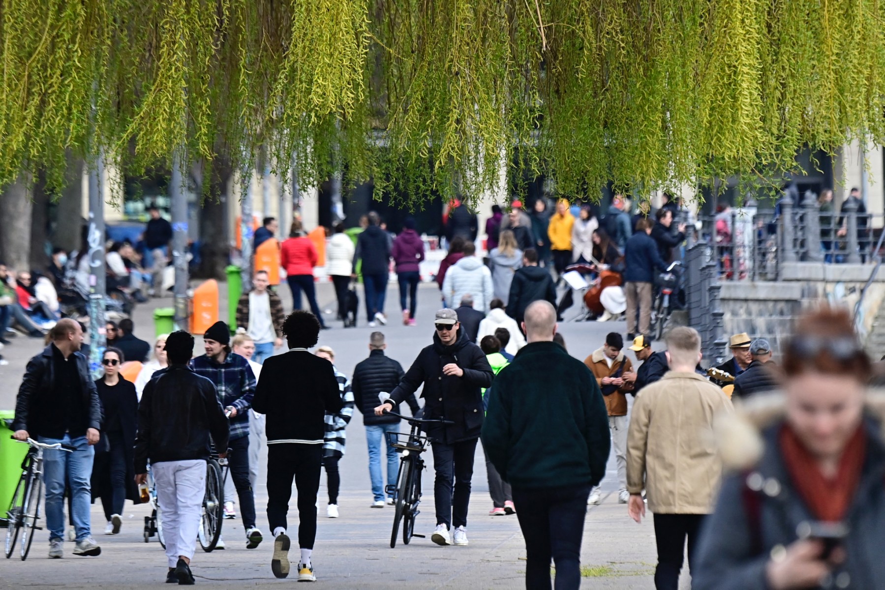 People walk along the Spree in Berlin.
