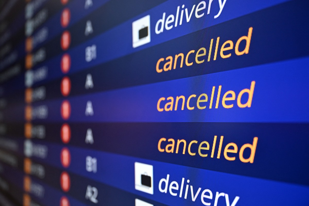 Cancelled flights are seen on an info board in Frankfurt airport.