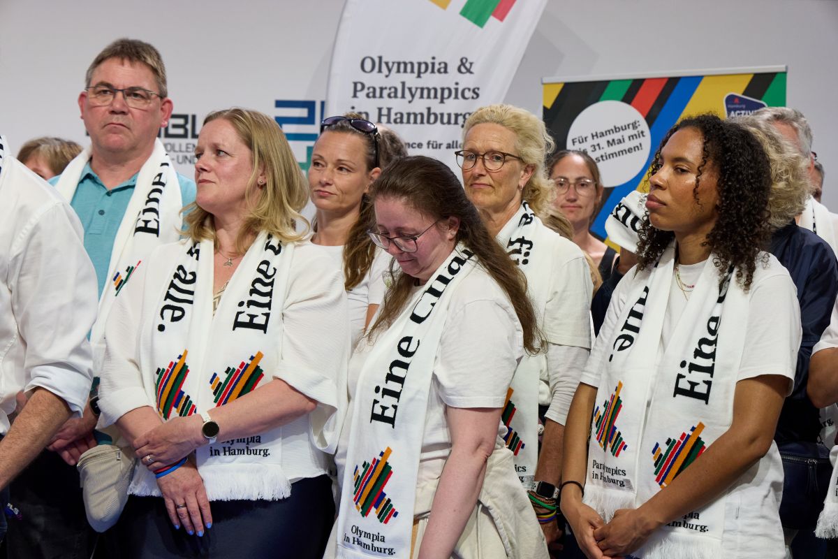 People wearing Olympic scarves look severely glum.