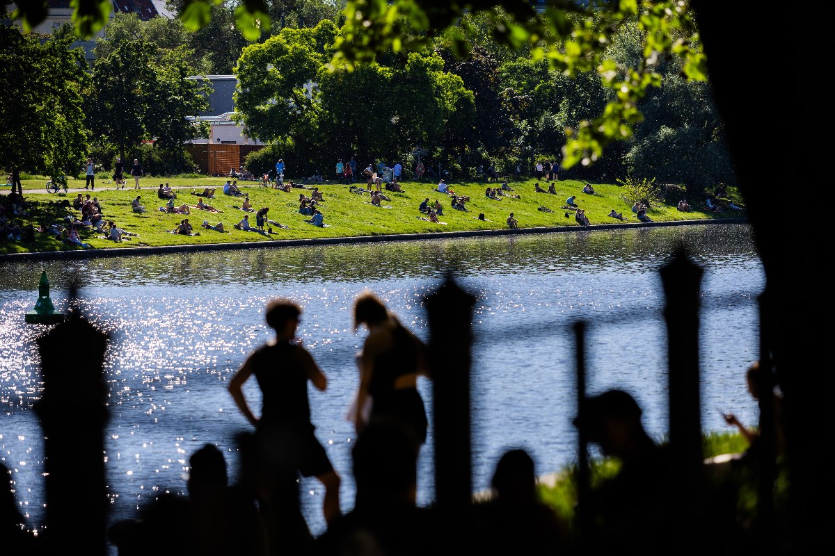 People enjoy sunny weather at the Landwehrkanal in Berlin
