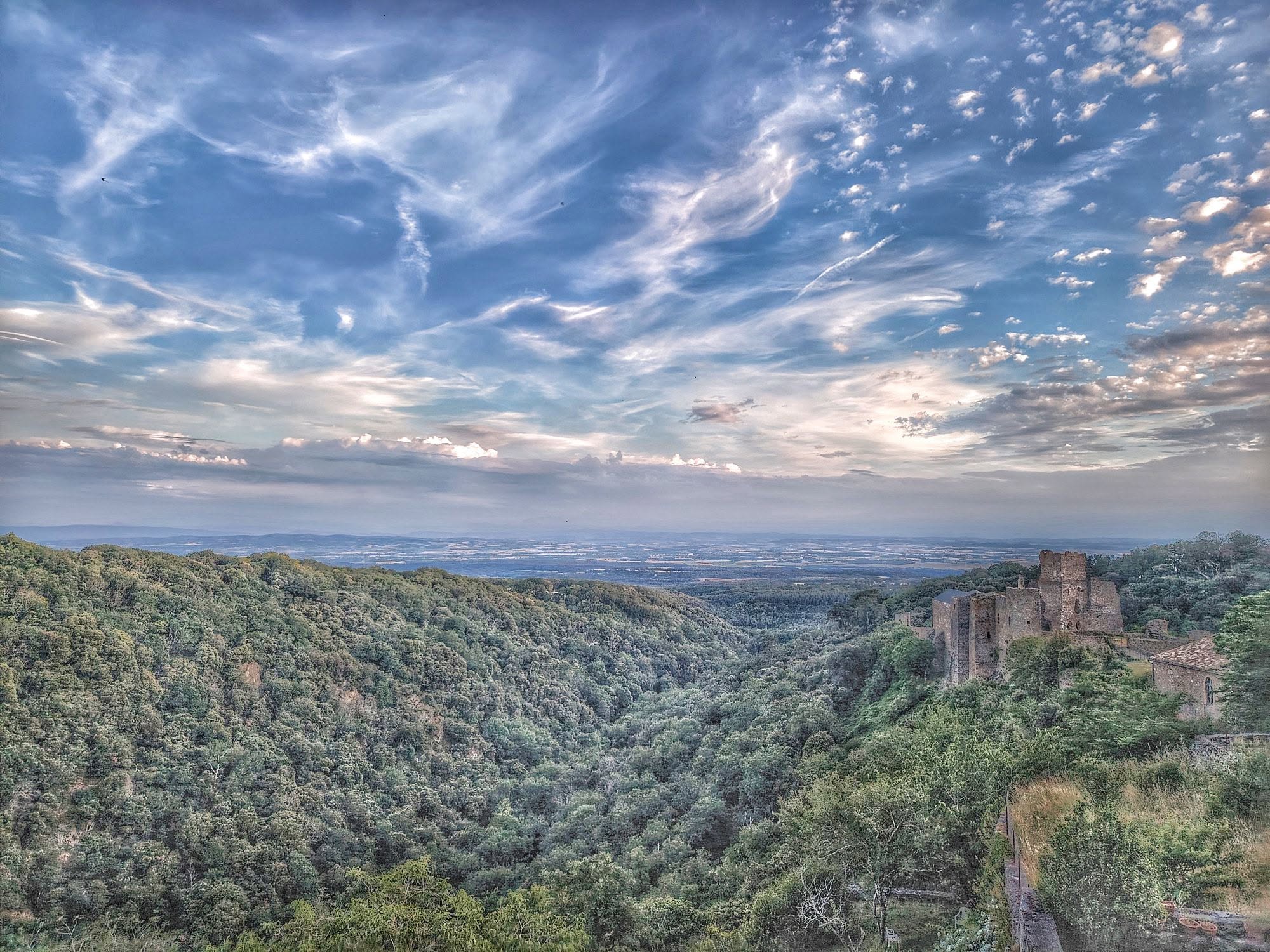 Evening cloudscape over the Château de Saissac, and Vernassonne ravine, from our garden. By Pierre Thomas
