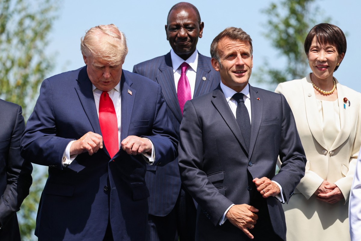 US President Donald Trump examines his tie.