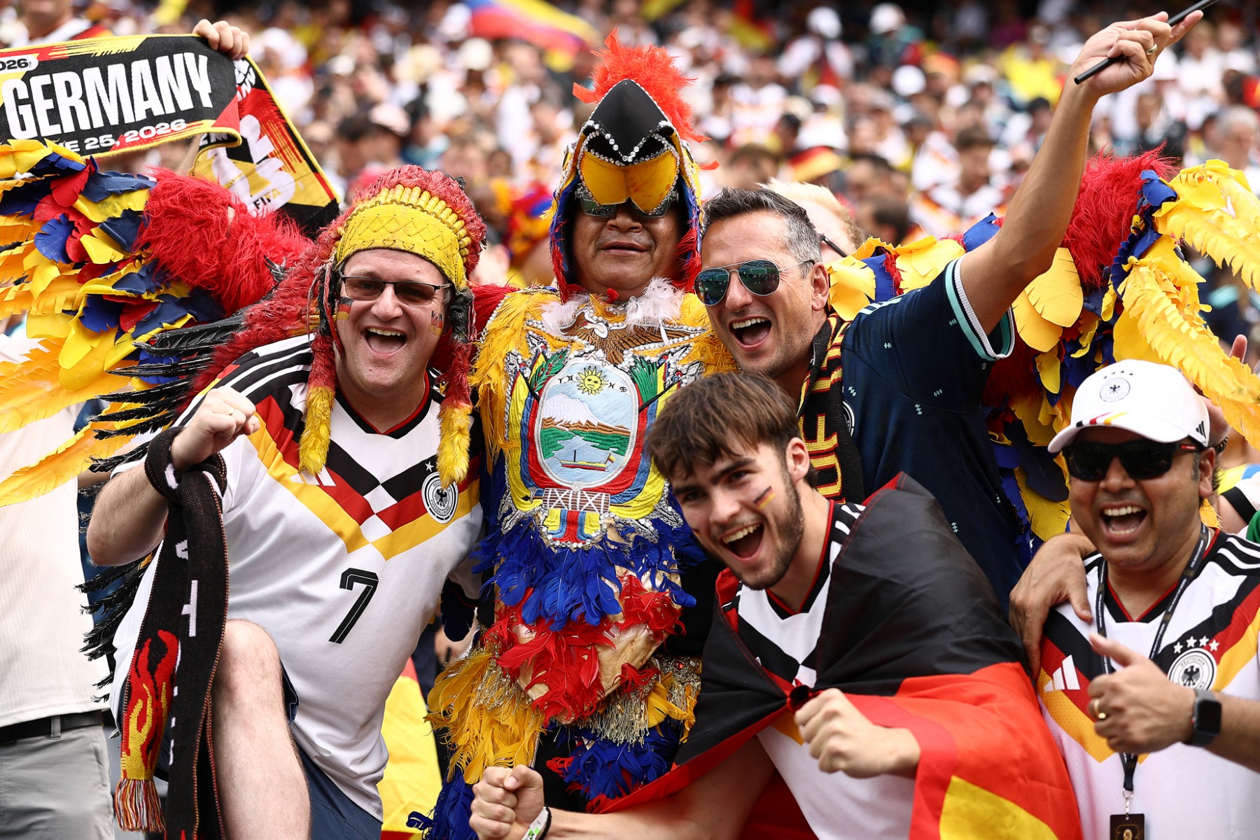 Football fans in wild headdresses are seen at a world cup stadium.