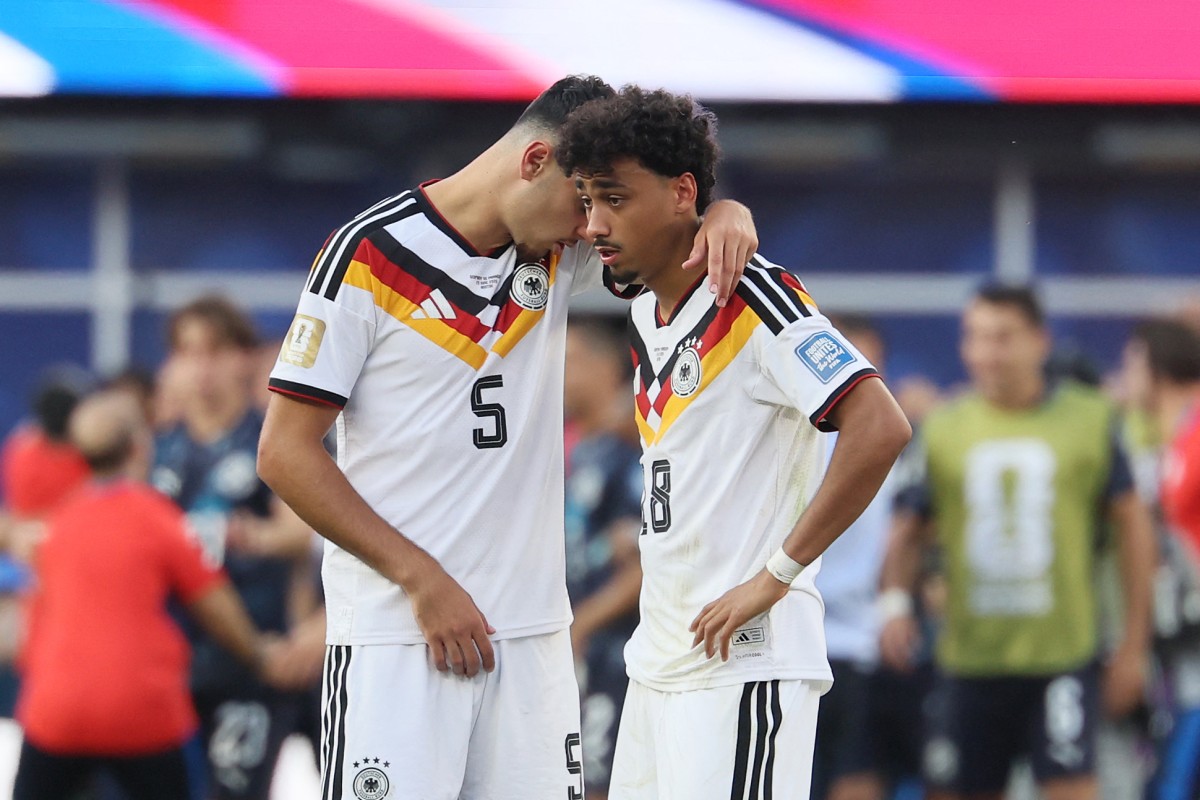 Germany's defender Aleksandar Pavlovic and Nathaniel Brown react after losing the penalty shootout of the 2026 World Cup round of 32 football match between Germany and Paraguay. 